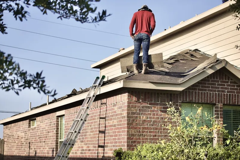 Professional roofer working on a residential roof in Little Balboa Island